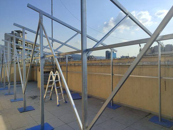 Tall steel frame going up on the roof