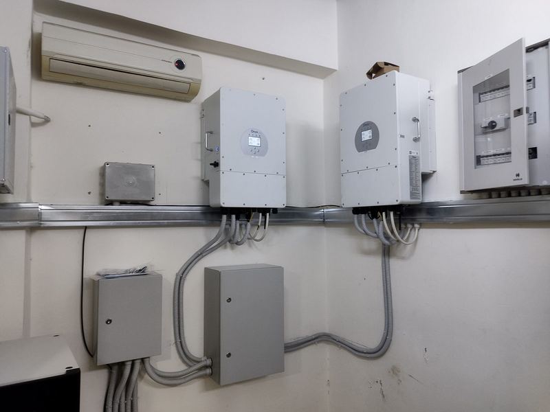 Two hybrid inverters with protection boxes
