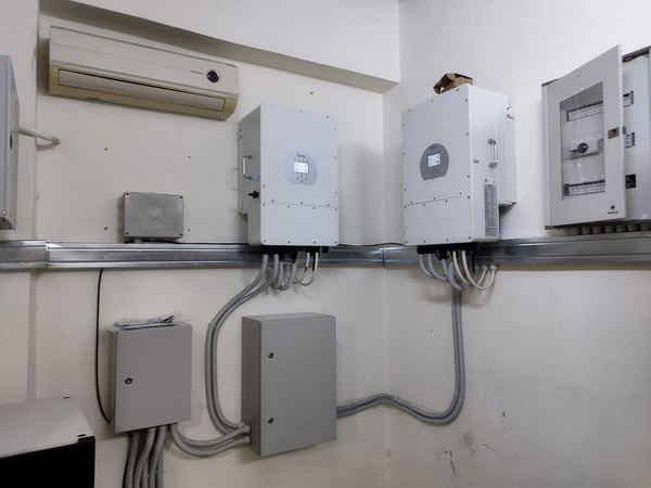 Two hybrid inverters with protection boxes